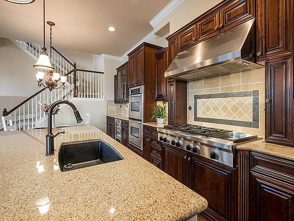 Kitchen with 6 burner stove, semi walk in pantry, trash compactor, double oven, wine fridge, refrigerator