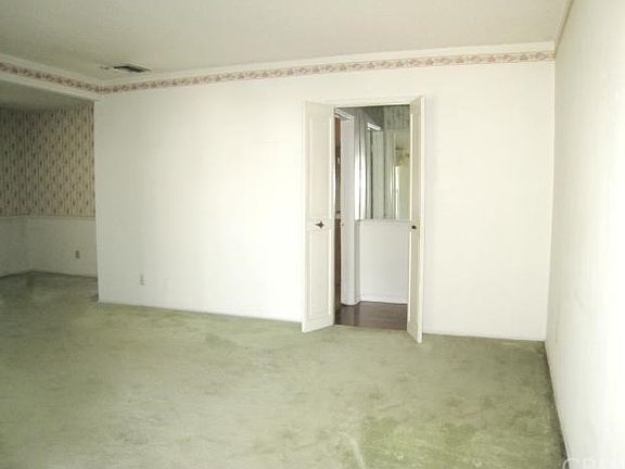 Double doors lead to hallway, bathroom and bedrooms.  To the left is the formal dining room.