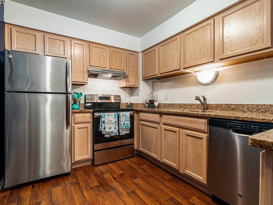 Modern kitchen with stainless steel appliances at Prentiss Pointe Apartments in Harrison Township, MI