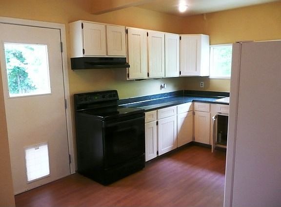 Kitchen with new laminated flooring and newer appliances