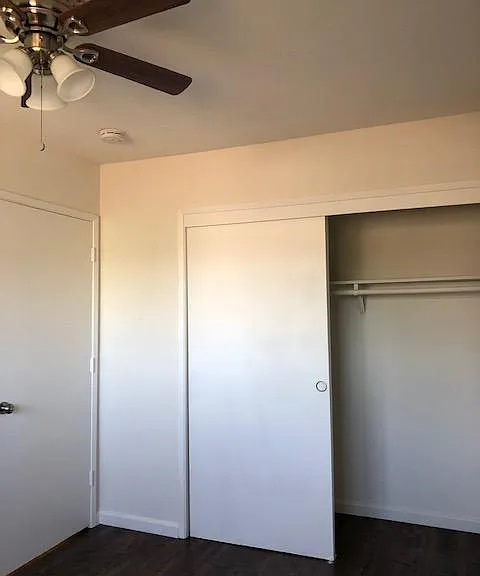 Bedroom has a large window, ceiling fan, wood laminate flooring and large 5 foot closet.