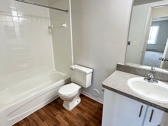 Upgrades from wood plank flooring to subway tile bath surround to nickel faucets and sleek white cabinets.