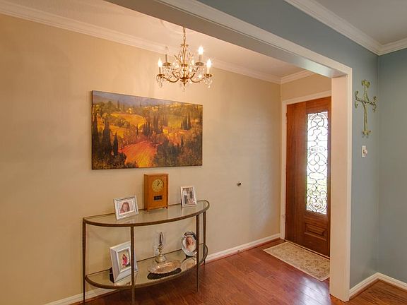 Leaded glass mahogany front door to the foyer. The glass chandelier adds the right touch for your en