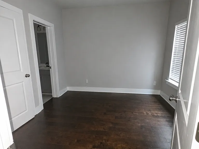 bottom level bedroom with closet and full bathroom