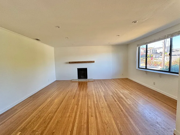 Large living room with gas fireplace and mantel.