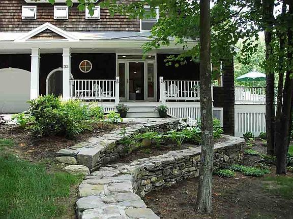 Lovely rock walls provide inviting approach