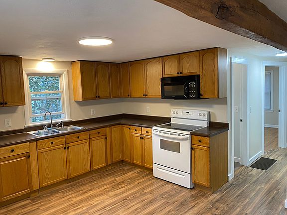 Kitchen and hallway. First door is bathroom, second door is one of the bedrooms.