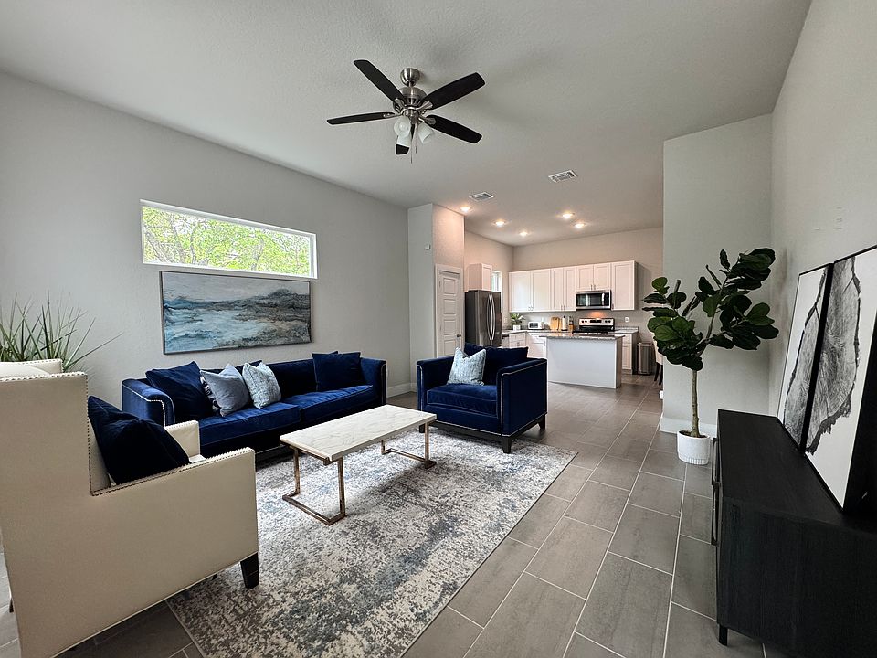Welcome Home! This first floor living room opens up to the kitchen. The room is bright, open and features modern furniture. 

Upstairs you'll find a 2nd living room (loft) and 3 bedrooms.