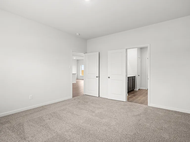 The master suite of the Cypress plan has a spacious bedroom, en-suite bathroom and walk-in closet.