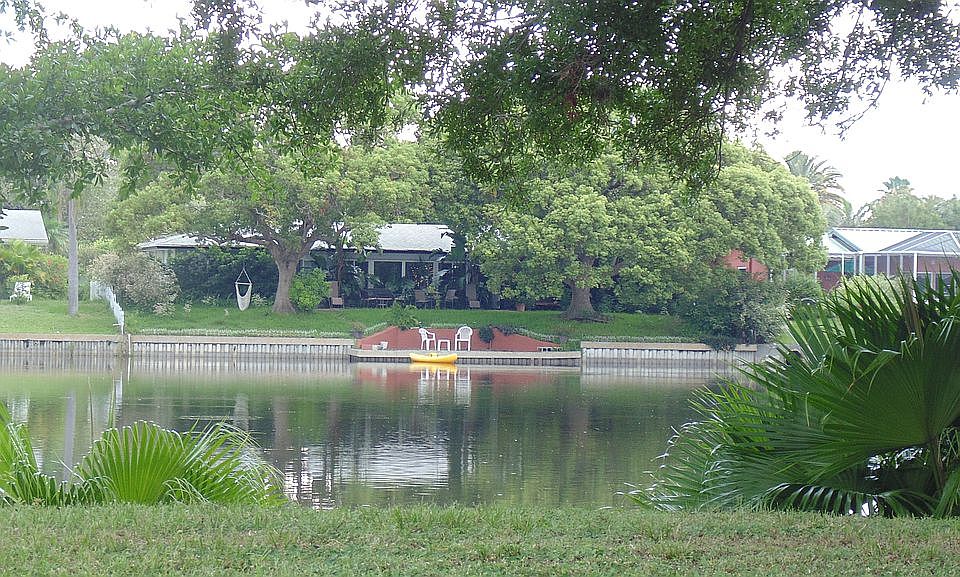 Back of the home with lake 