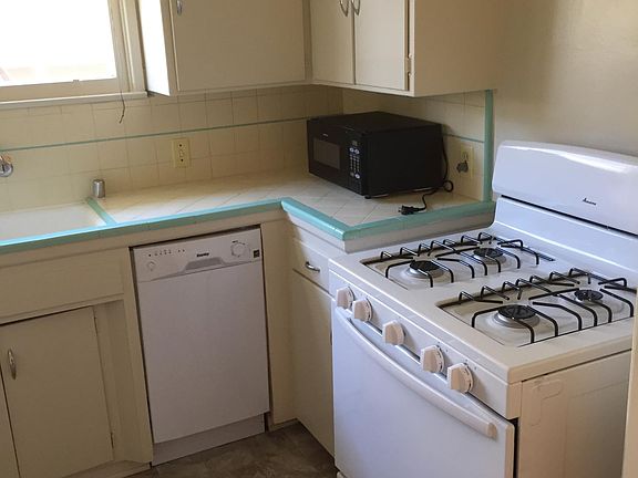 kitchen with new stove, dishwasher and linoleum