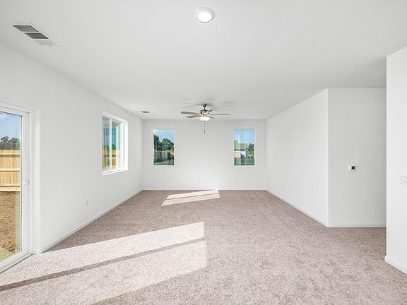 The family room is spacious with a ceiling fan.
