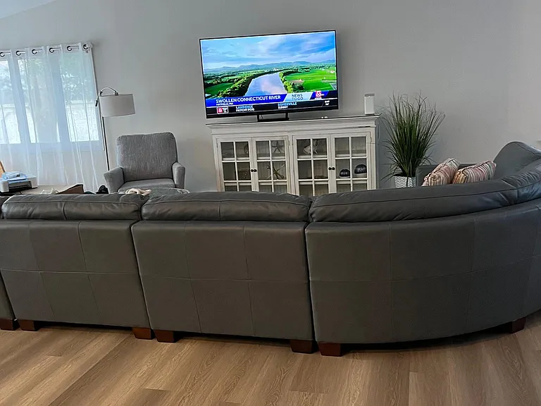 Living room with smart tv and hight end Italian leather sectional.