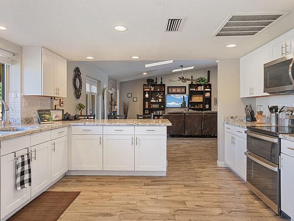 Stainless steel appliances. Kitchen overlooks the family room.