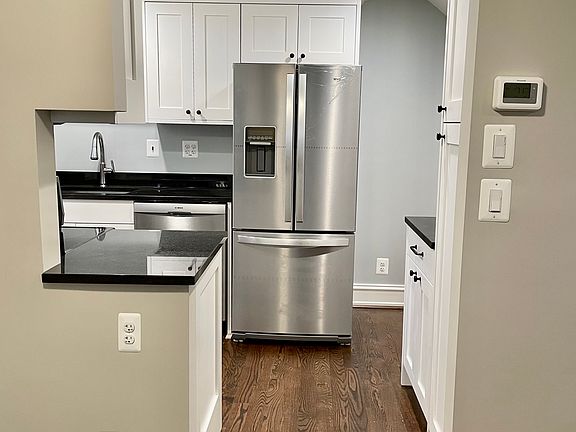 Remodeled kitchen with custom cabinets, newer appliances and granite countertops.