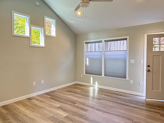 Private entry and Living room with feature windows, double hung windows with custom blinds, ceiling fan and air conditioning.