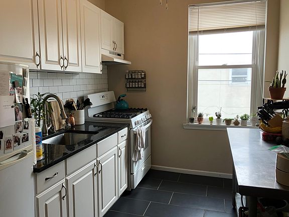 Kitchen with slate floor, ceiling fan and lots of sunlight