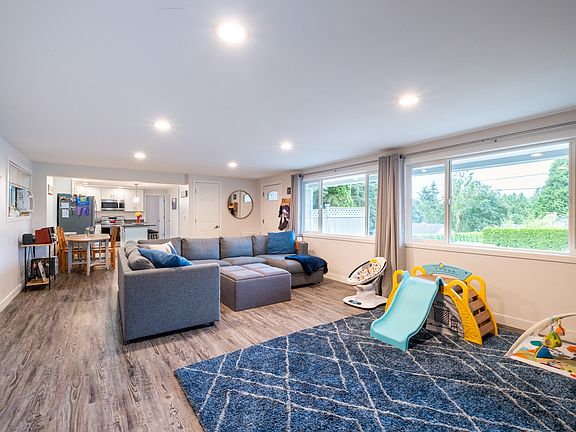 The massive living room offers ample space for entertaining, featuring large windows and an open layout. It's the perfect focal point for gatherings and activities in the house.