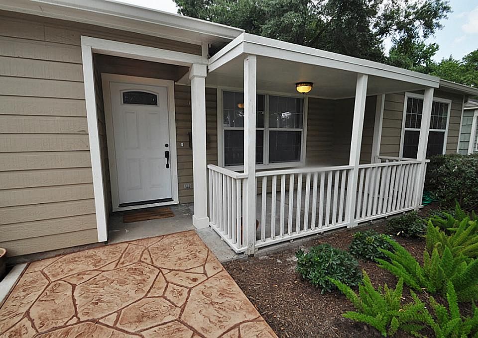 Beautiful covered front patio is a great place to enjoy your morning coffee! New stamped concrete!