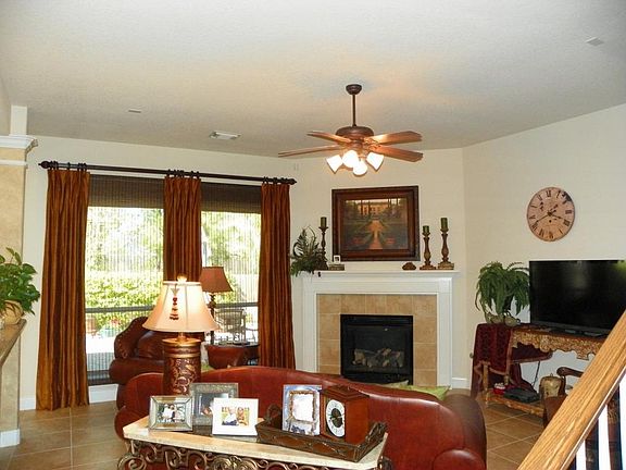 Family room has tile floors,  corner fireplace with gas logs & wndows viewing back yard.