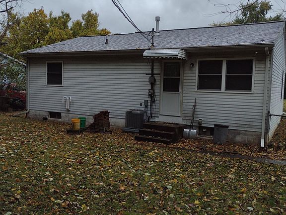Rear of home, showing leaf covered yard
