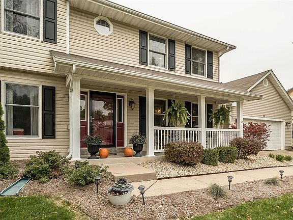 Large covered front porch and beautiful landscaping.
