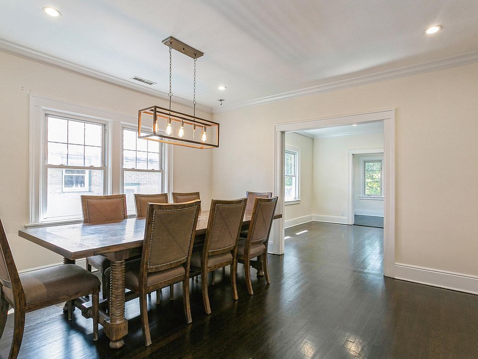 Bright, large dining room with attractive chandelier.
The dining table and chairs are available to be used by tenant if desired.