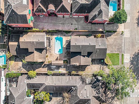 Mirror image homes flank either side of the sparkling pool with diving board making for great backyard parties!