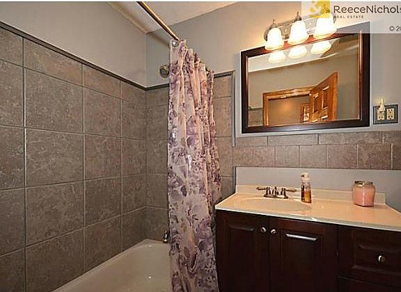 Main bath has newer tile, vanity and paint