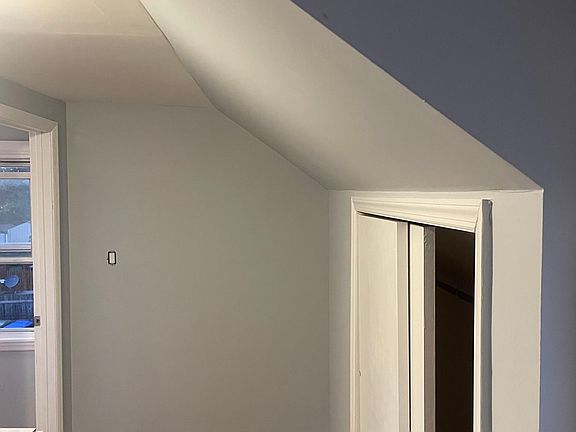 Hallway leading into the bedroom. Storage on the right.