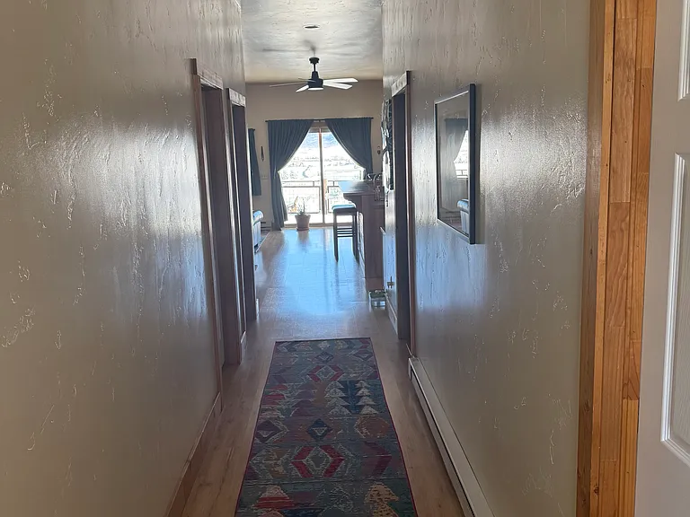 Hallway into main living space. Door on right is to main bedroom and door on left is to guest bedroom