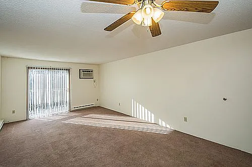 Living room with wall unit air conditioning