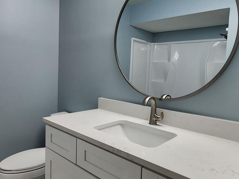 Bathroom, newly rehabbed, quartz vanity top, porcelain floor, lots of shelves in bath and shower surround