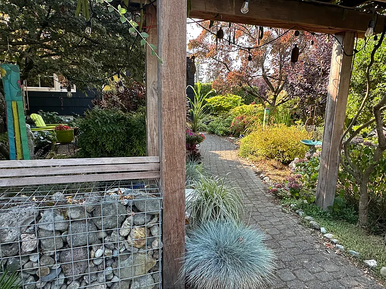 The garden walkway welcomes you home through beautifully landscaped grounds and seasonal color