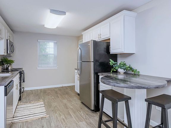 Embrace culinary elegance in Woodcrest Kitchens with the added charm of a breakfast bar.