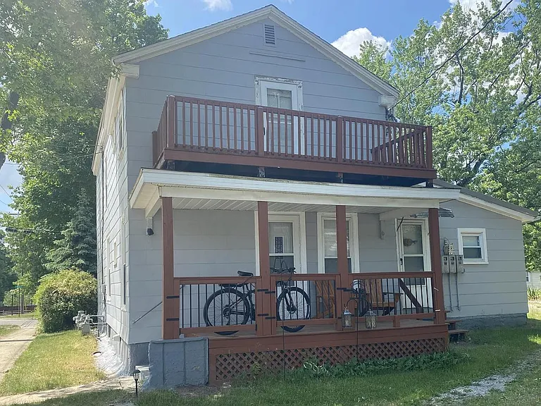 Rear of 19 Mead St. does offer limited off street parking. A back door is available for both lower units. The two story porch really adds some vital spring/summer living space with mature trees for shade and a lovely view in this very peaceful neighborhoo