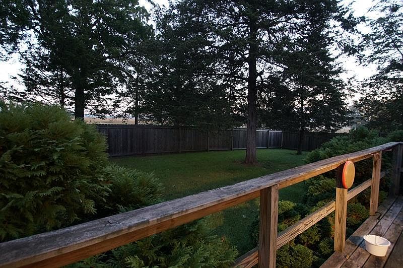 large fenced yard with deck
