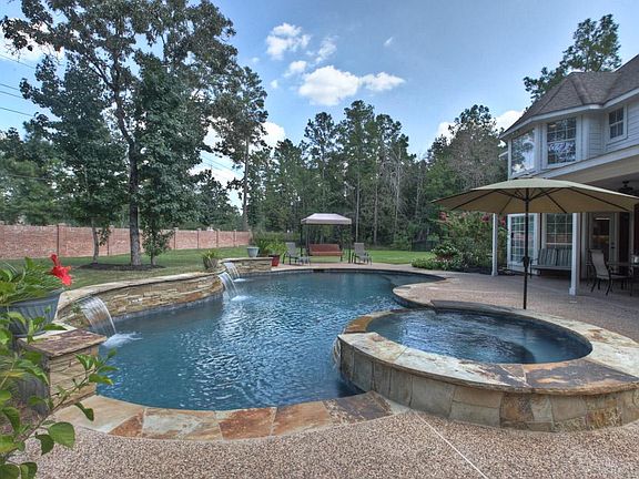 A sparking Jameson Custom Pool and Spa with plenty of patio space for sunning.