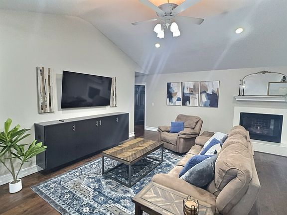 Comfortable recliners with 65" Smart TV and gas fireplace.