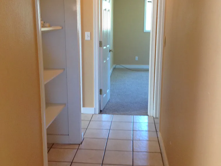 Hallway that leads to bedrooms, bathroom