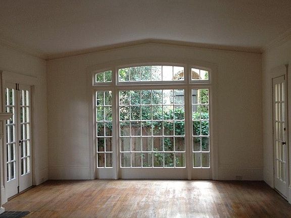 Living room, showing doors to front porch and rear garden, as well as a little of the fireplace hearth