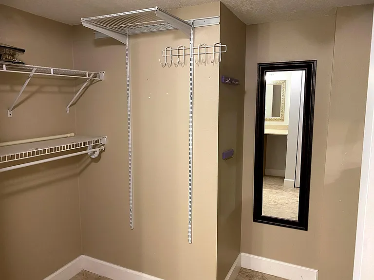 Large walk-in closet, recently painted white.