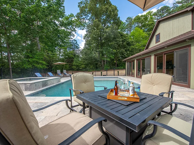 Pool, fire table and pool house.
