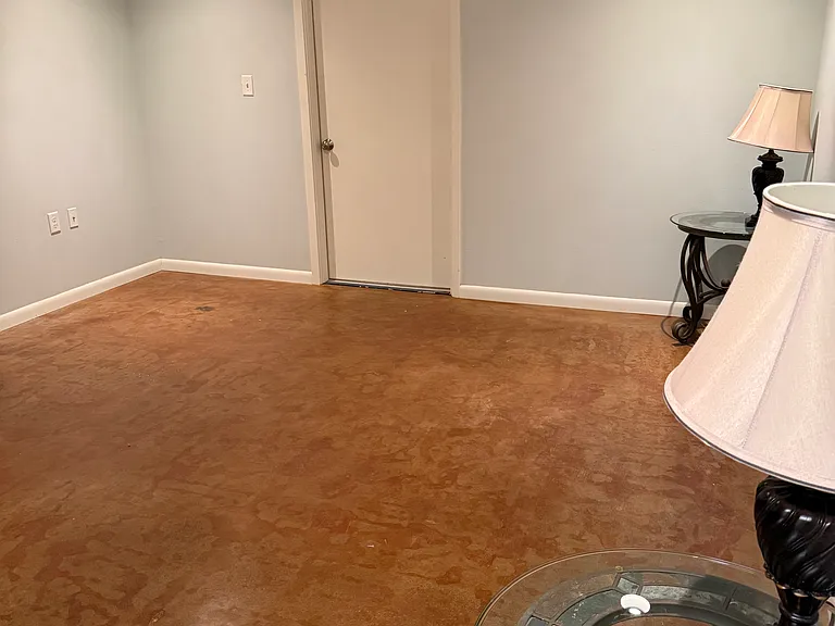 Larger bedroom view from closet. Door is garage access.