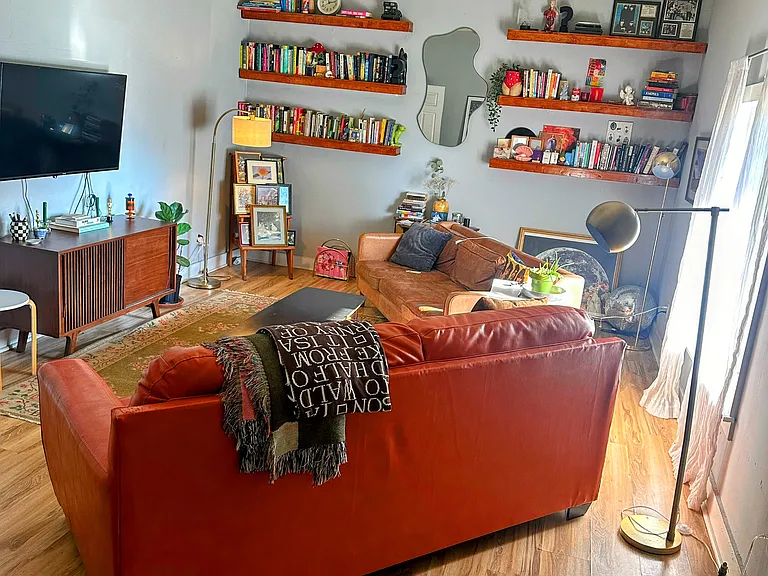 Living room shown furnished with plenty of wall space for additional pieces.