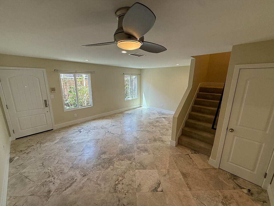 Living Room and Dining Area + Stairs/Under-Stair Closet.