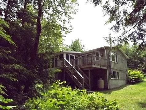 back of home with deck and screen porch