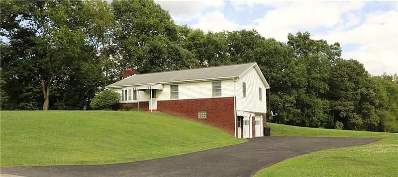 The nice asphalt drive allows plenty of room to get in and out of the garage or just extra parking space.