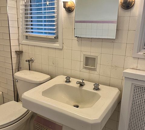 Vintage bathroom with lots of character and updated shower and also freshly painted.