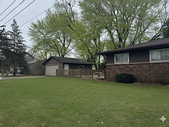 Two car garage with fenced yard.